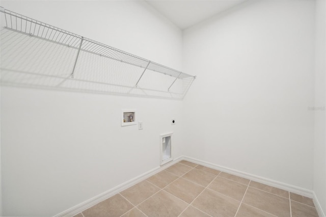 laundry room featuring baseboards, light tile patterned floors, laundry area, hookup for a washing machine, and electric dryer hookup