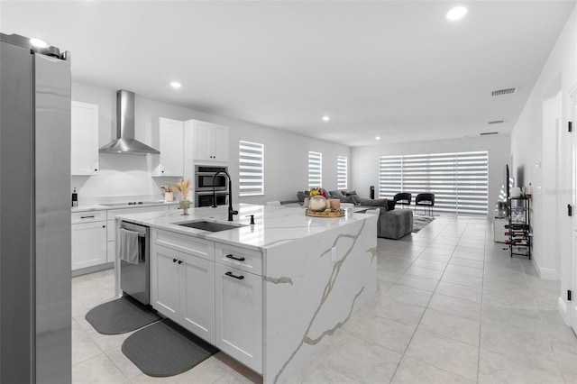 4911 Shady Pines Dr, Saint Cloud, FL 34772 - kitchen featuring wall chimney exhaust hood, stainless steel appliances, white cabinets, open floor plan, and a sink