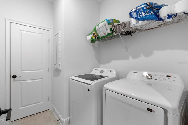 4911 Shady Pines Dr, Saint Cloud, FL 34772 - washroom featuring washer and clothes dryer, light tile patterned floors, and baseboards