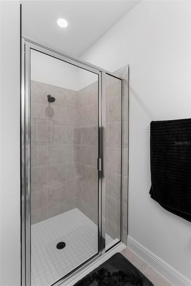 4911 Shady Pines Dr, Saint Cloud, FL 34772 - bathroom with a shower stall, baseboards, and tile patterned floors