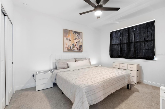 4911 Shady Pines Dr, Saint Cloud, FL 34772 - bedroom featuring light carpet, baseboards, ceiling fan, and a closet