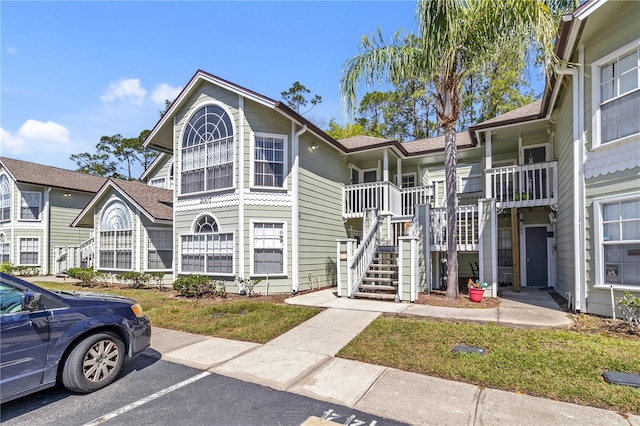 2007 Royal Bay Blvd Unit 144, Kissimmee, FL 34746 - view of building exterior with stairs and uncovered parking
