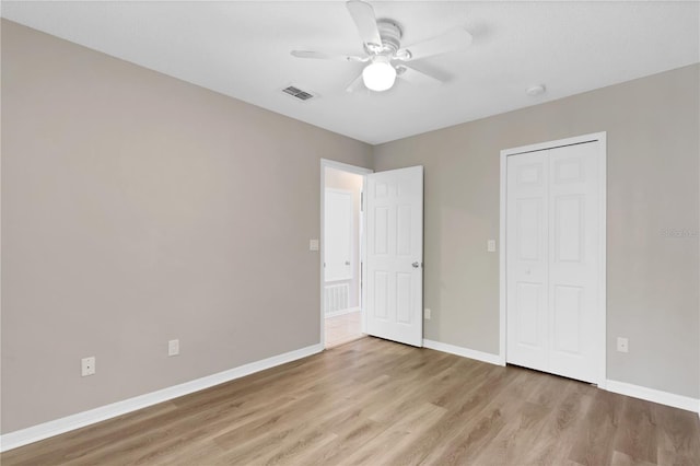 2007 Royal Bay Blvd Unit 144, Kissimmee, FL 34746 - unfurnished bedroom featuring light wood-type flooring, a closet, baseboards, and visible vents