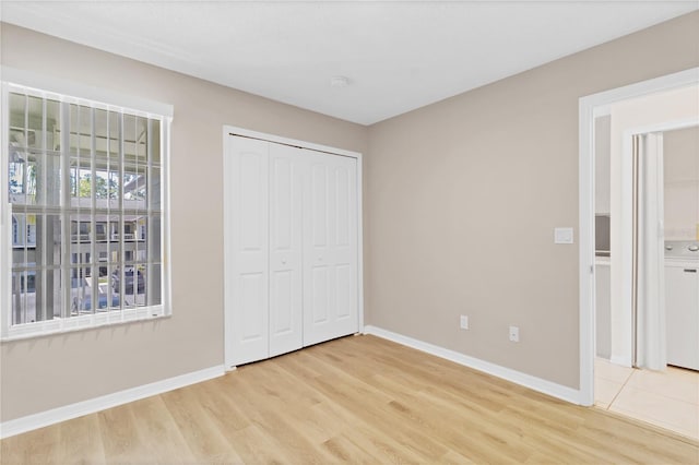 2007 Royal Bay Blvd Unit 144, Kissimmee, FL 34746 - unfurnished bedroom featuring light wood-style flooring and baseboards