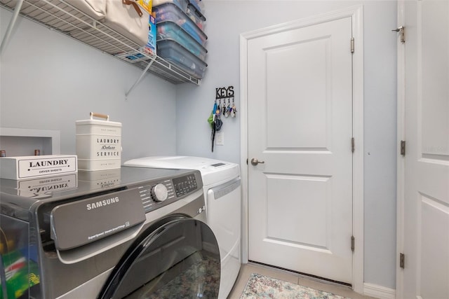 laundry area with washing machine and clothes dryer and laundry area