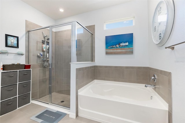 bathroom with a bath, a stall shower, and tile patterned floors