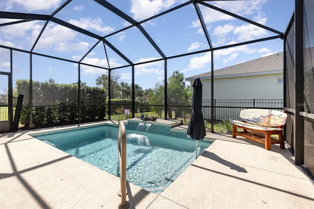 outdoor pool featuring glass enclosure and a patio area