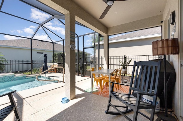 exterior space featuring glass enclosure, a fenced in pool, fence, and a ceiling fan
