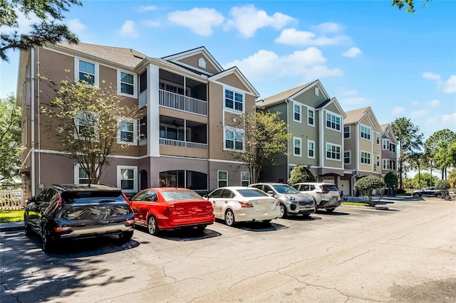3384 Corona Village Way Unit 202, Orlando, FL 32835 - view of building exterior featuring a residential view and uncovered parking