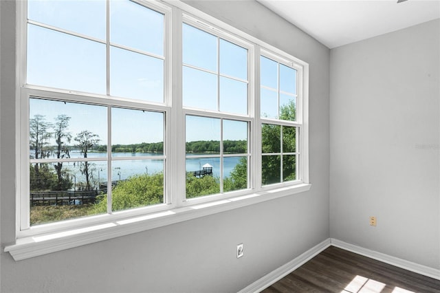 3384 Corona Village Way Unit 202, Orlando, FL 32835 - unfurnished room with a water view, baseboards, and dark wood finished floors