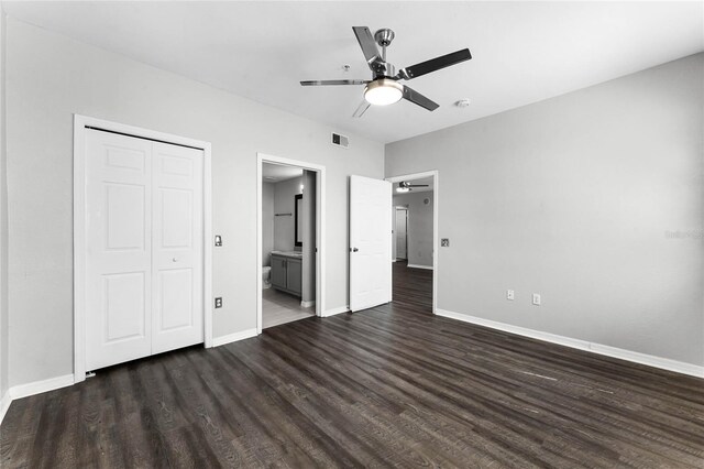3384 Corona Village Way Unit 202, Orlando, FL 32835 - unfurnished bedroom with dark wood-style flooring, a closet, baseboards, and visible vents