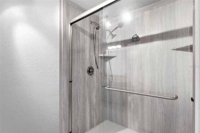 3384 Corona Village Way Unit 202, Orlando, FL 32835 - full bath featuring a textured wall and a shower stall