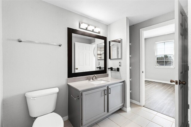 3384 Corona Village Way Unit 202, Orlando, FL 32835 - bathroom with toilet, vanity, tile patterned floors, and baseboards
