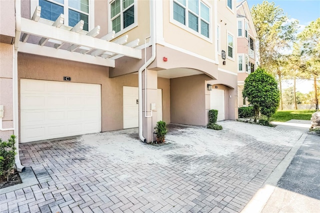 3384 Corona Village Way Unit 202, Orlando, FL 32835 - entrance to property with driveway, stucco siding, and an attached garage