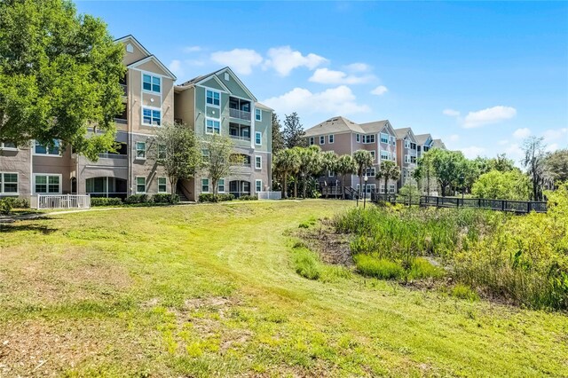 3384 Corona Village Way Unit 202, Orlando, FL 32835 - surrounding community featuring a residential view, fence, and a yard