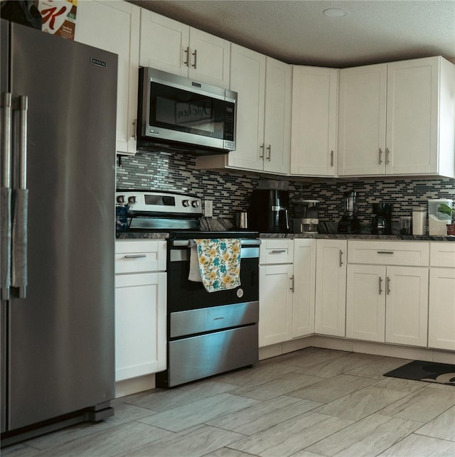 345 W Seminole Ave, Eustis, FL 32726 - kitchen with appliances with stainless steel finishes, backsplash, dark stone counters, a textured ceiling, and white cabinets