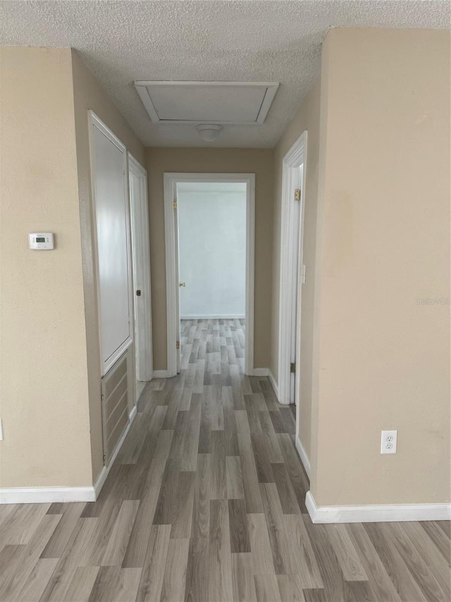 345 W Seminole Ave, Eustis, FL 32726 - hall featuring wood finished floors, a textured ceiling, and baseboards