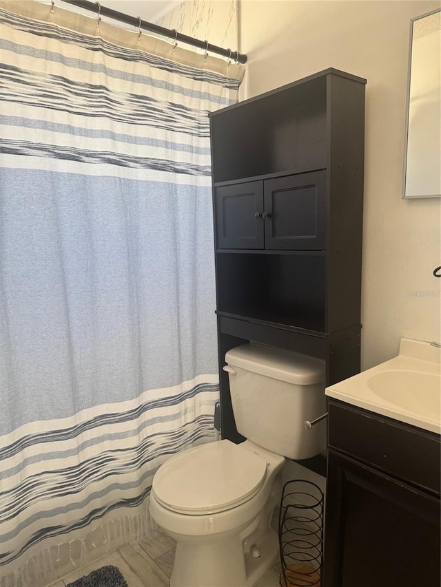 345 W Seminole Ave, Eustis, FL 32726 - full bath featuring toilet, vanity, and tile patterned flooring