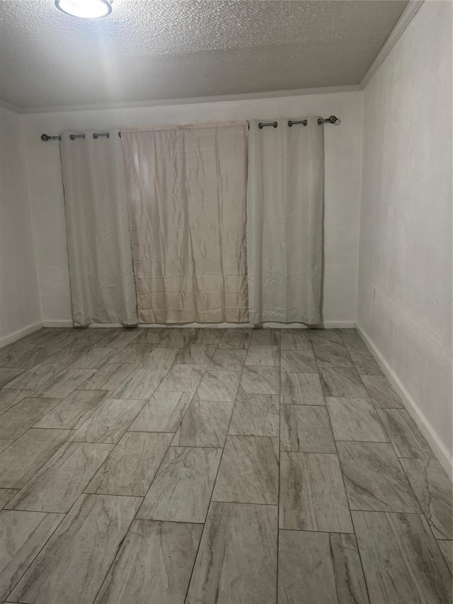 345 W Seminole Ave, Eustis, FL 32726 - unfurnished room featuring a textured ceiling and baseboards