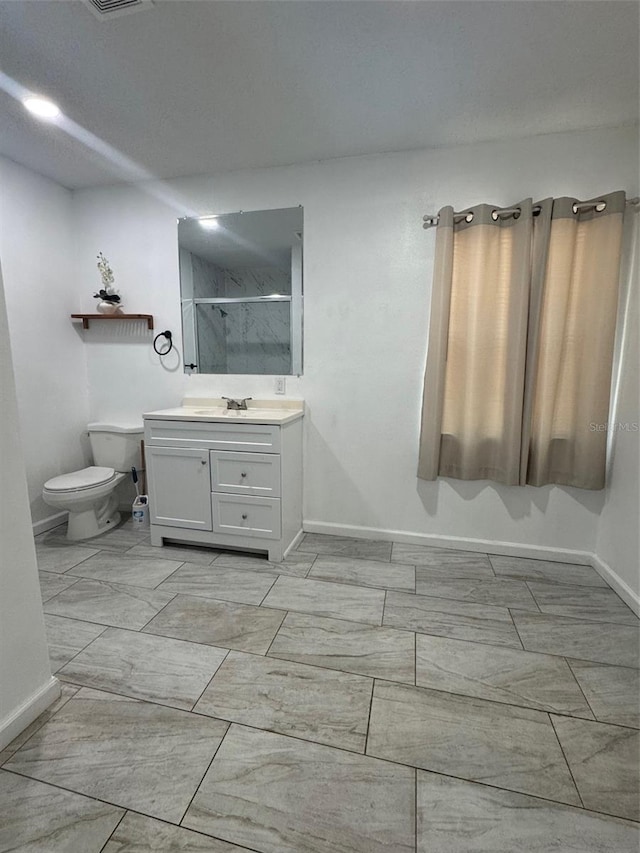345 W Seminole Ave, Eustis, FL 32726 - bathroom with a shower stall, baseboards, vanity, toilet, and marble finish flooring
