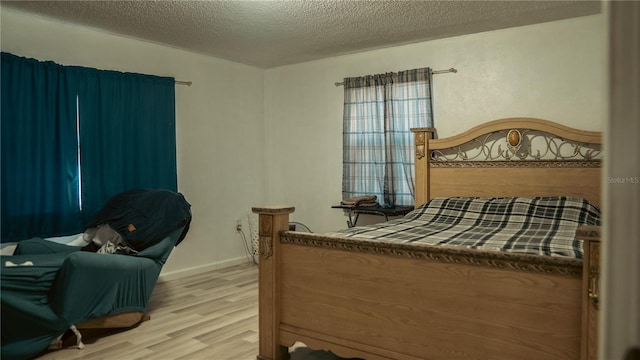 345 W Seminole Ave, Eustis, FL 32726 - bedroom with wood finished floors and a textured ceiling