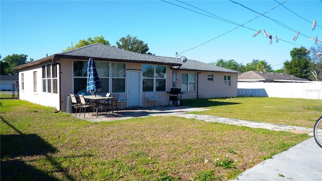 345 W Seminole Ave, Eustis, FL 32726 - rear view of house with a patio area and roof with shingles