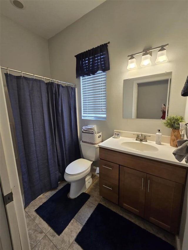full bath with toilet, curtained shower, vanity, and tile patterned flooring