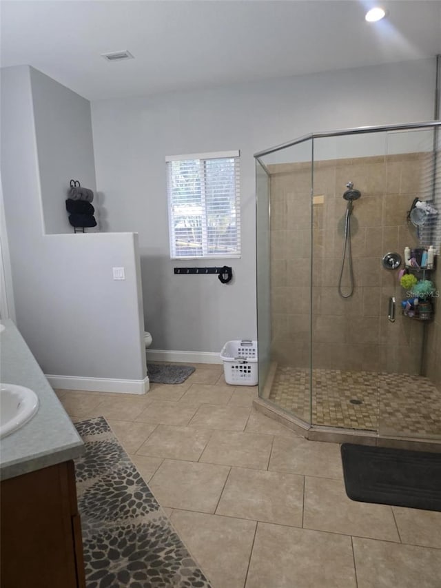 full bath featuring tile patterned floors, vanity, visible vents, and a stall shower