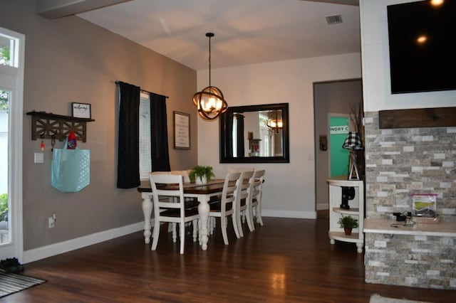 dining space with visible vents, baseboards, an inviting chandelier, and wood finished floors