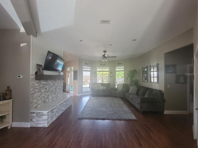 living area featuring wood finished floors, a ceiling fan, and visible vents