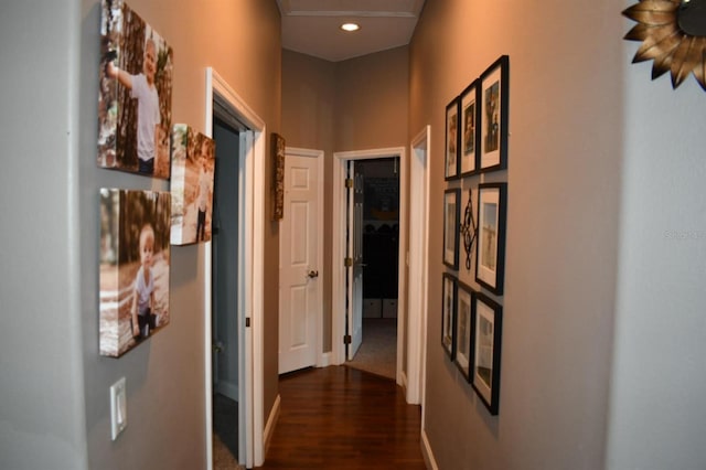 hallway featuring baseboards, dark wood-style floors, and recessed lighting
