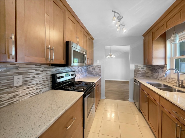 6 Almond Trce, Ocala, FL 34472 - kitchen with backsplash, brown cabinets, appliances with stainless steel finishes, and a sink