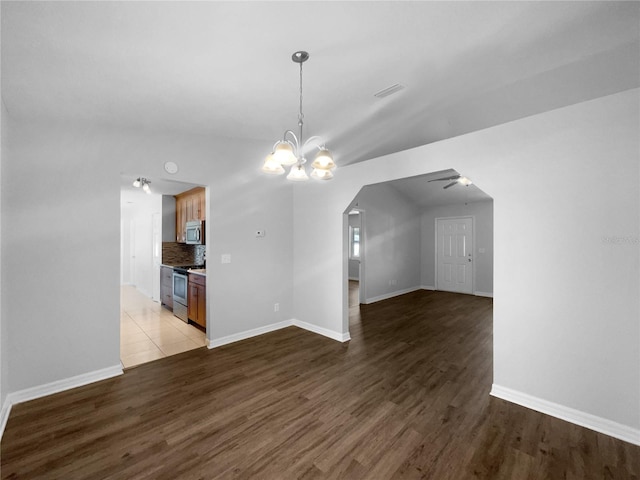 6 Almond Trce, Ocala, FL 34472 - interior space featuring ceiling fan with notable chandelier, visible vents, wood finished floors, and arched walkways