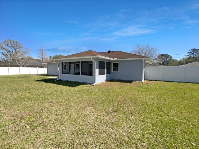 6 Almond Trce, Ocala, FL 34472 - back of house with a fenced backyard, stucco siding, a yard, and a sunroom