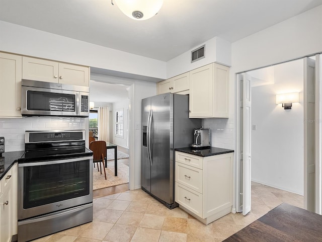 kitchen with visible vents, white cabinets, baseboards, appliances with stainless steel finishes, and backsplash