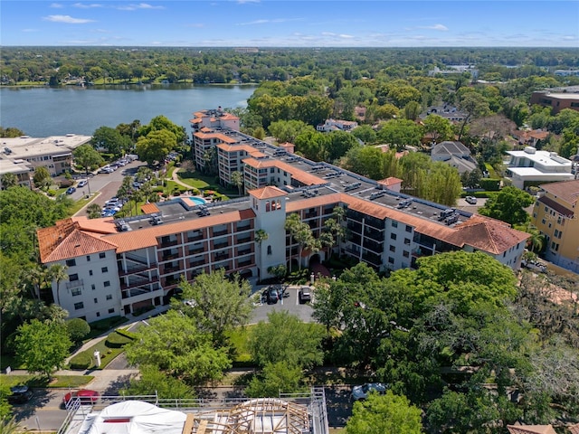 birds eye view of property featuring a water view and a view of trees