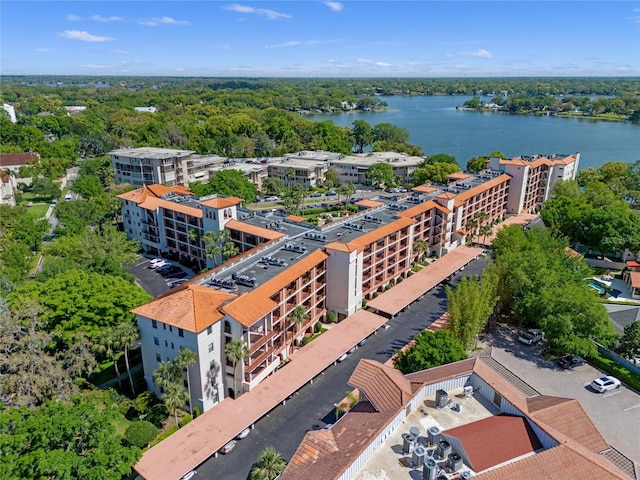 aerial view featuring a water view and a wooded view