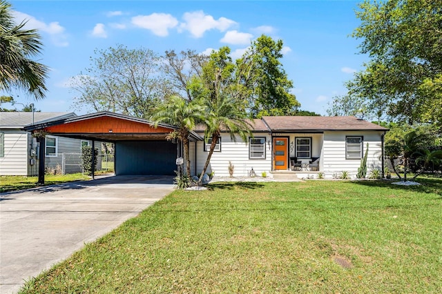 407 E Jersey St, Orlando, FL 32806 - view of front of home featuring driveway, an attached carport, and a front yard