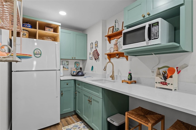 407 E Jersey St, Orlando, FL 32806 - kitchen featuring green cabinets, white appliances, open shelves, and a sink