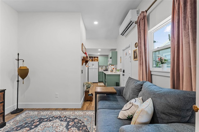 407 E Jersey St, Orlando, FL 32806 - living room with light wood finished floors, recessed lighting, a wall mounted air conditioner, and baseboards