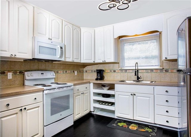 407 E Jersey St, Orlando, FL 32806 - kitchen featuring white appliances, dark wood-style floors, a sink, light countertops, and white cabinetry