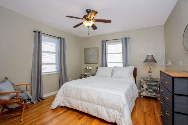 407 E Jersey St, Orlando, FL 32806 - bedroom with baseboards, wood finished floors, and a ceiling fan