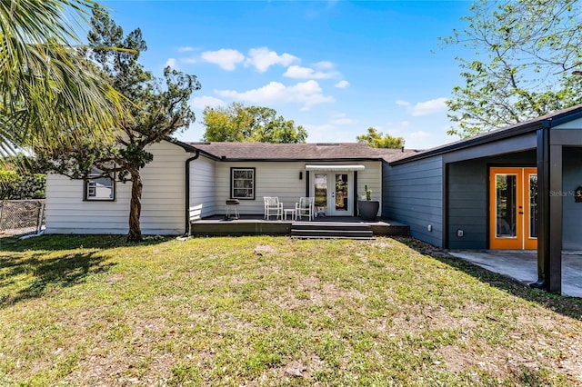 407 E Jersey St, Orlando, FL 32806 - back of property with a yard, french doors, and a wooden deck