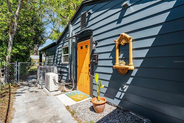 407 E Jersey St, Orlando, FL 32806 - entrance to property featuring ac unit, a gate, and fence