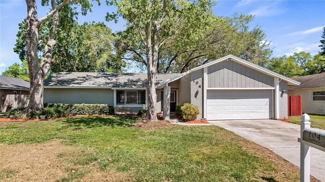 ranch-style house with stucco siding, an attached garage, concrete driveway, and a front lawn