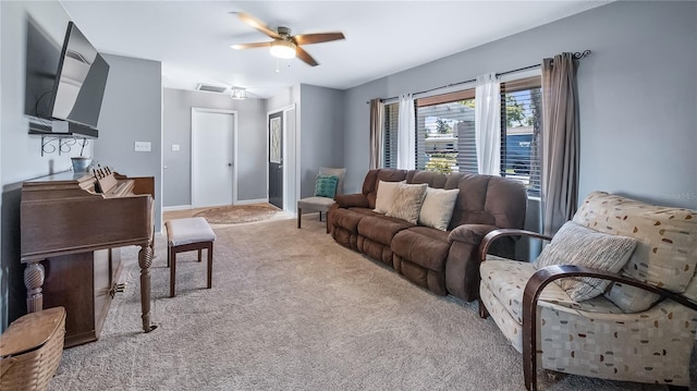 living room with visible vents, baseboards, light colored carpet, and a ceiling fan