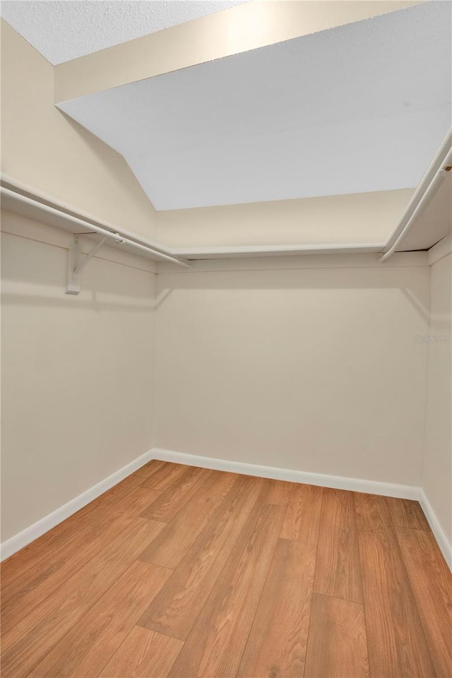 walk in closet featuring light wood finished floors