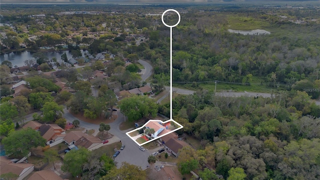 bird's eye view with a wooded view and a water view