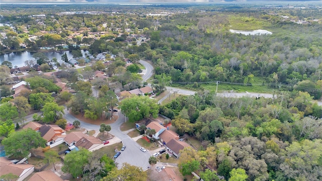 aerial view featuring a residential view, a water view, and a view of trees