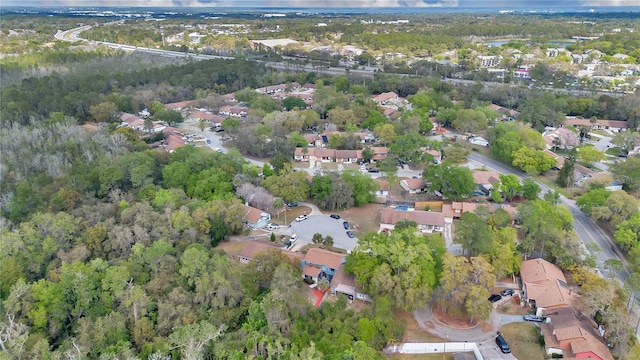 birds eye view of property featuring a residential view and a view of trees